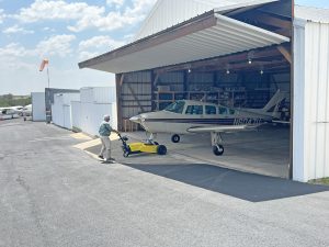 The AircraftCaddy a small aircraft tug pulling a small aircraft