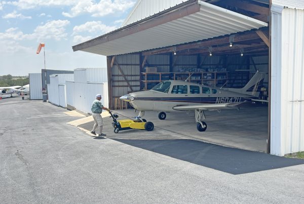 The AircraftCaddy a small aircraft tug pulling a small aircraft