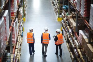 Material Handling Warehouse Managers Discussing Motorized Tugs