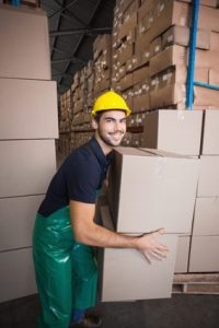 Warehouse worker loading up a pallet in a large warehouse