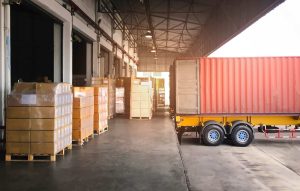 Pallets on a Loading Dock In Need of a Motorized Trailer Dolly