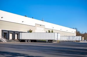 Warehouse trailer yard with trailers waiting to be moved by a motorized trailer dolly.