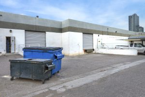 Dumpsters Sitting in a Parking Lot Waiting for a Motorized Dumpster Mover