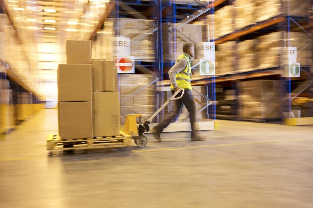 Improve Warehouse Ergonomics with a Few Tips and a Motorized Trailer Dolly